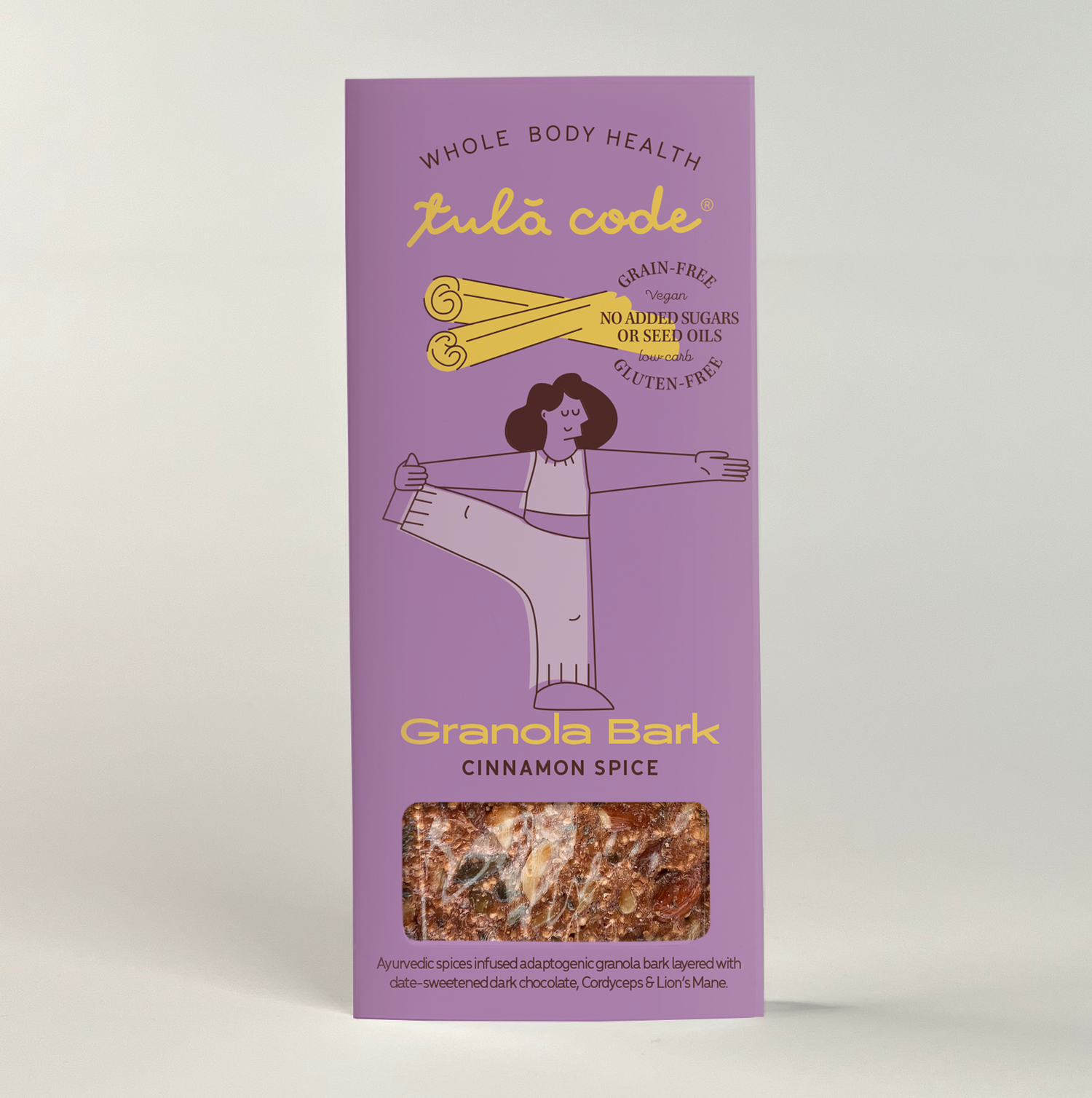 The image shows the packaging of our cinnamon spice granola bark. It is purple, with a yellow accent for the cinnamon and the type that reads &